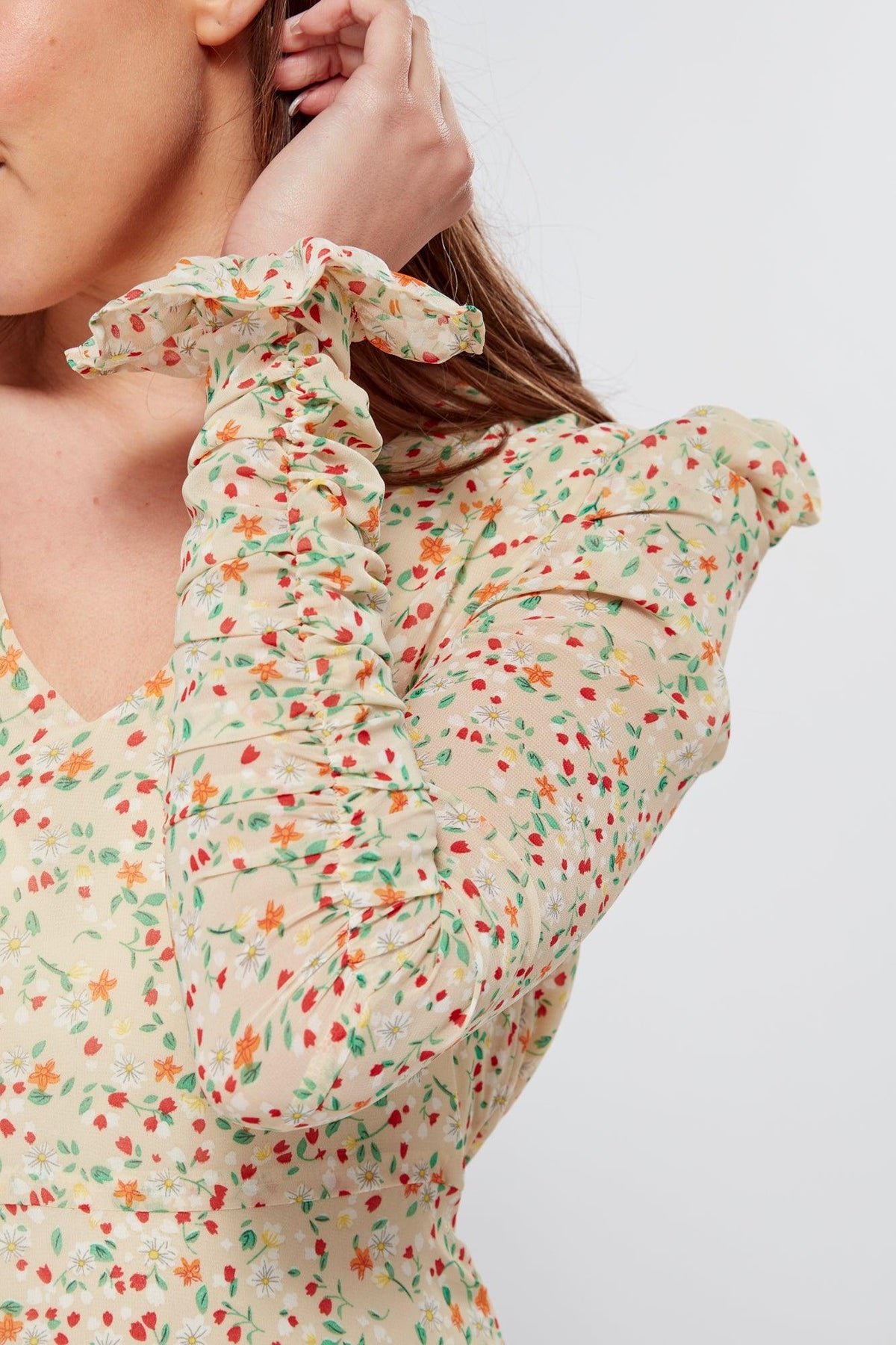 Introducing our Georgette beige floral midi dress, the perfect addition to your wardrobe for any special occasion. The dress features a stunning floral print on a beige georgette fabric that flows beautifully into a big frill. The design is nicely fitted on the waist and hips, creating a flattering silhouette, and then flowing into a frill for a feminine touch.