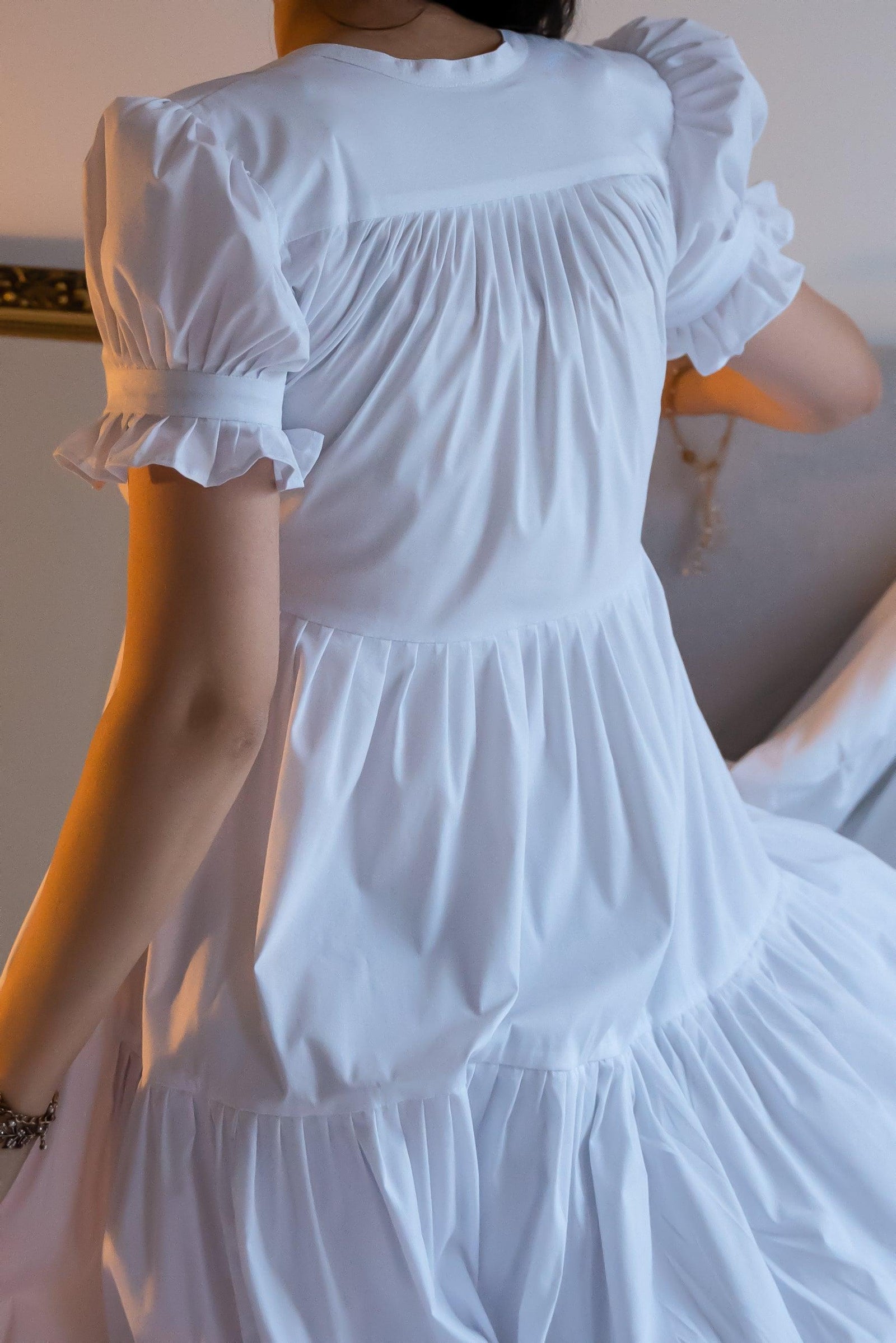 Showstopper alert! The dreamy Gia dress has a beautifully tiered skirt with immense volume. The skirt is guaranteed to make you feel like a thousand bucks yet it is also super easy and comfortable to wear. The material is a little stretchy but the looseness of the dress allows for plenty of extra space so please size down if you prefer a tighter fit. The neckline can be pulled close and tied with two straps and the sleeves are puffy.   Our model is 175 cm tall and wearing a size S.