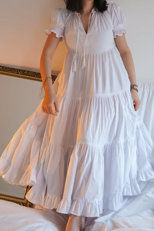 Showstopper alert! The dreamy Gia dress has a beautifully tiered skirt with immense volume. The skirt is guaranteed to make you feel like a thousand bucks yet it is also super easy and comfortable to wear. The material is a little stretchy but the looseness of the dress allows for plenty of extra space so please size down if you prefer a tighter fit. The neckline can be pulled close and tied with two straps and the sleeves are puffy.   Our model is 175 cm tall and wearing a size S.